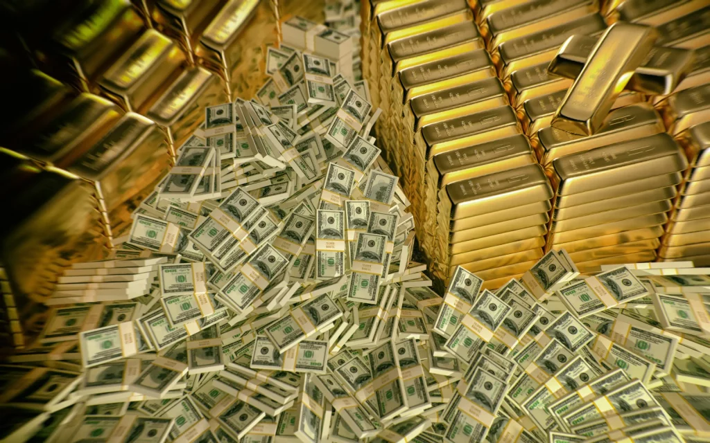 Gold bars stacked in front of dollars