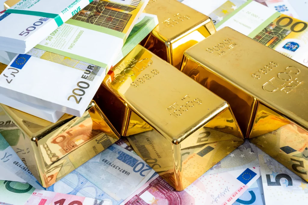 Gold bars stacked in front of euro banknotes, representing wealth, investment, and financial stability.