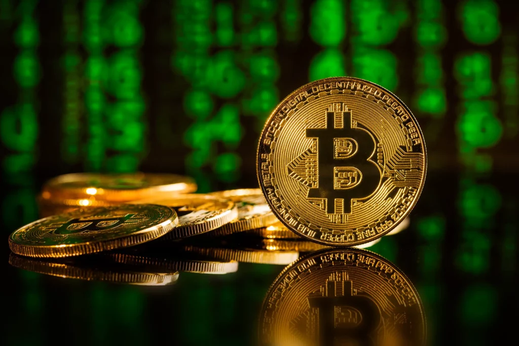 Golden Bitcoin coin on dark background, representing cryptocurrency investment and digital finance.
