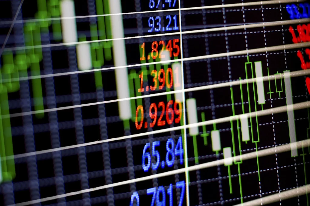 Interior of a stock exchange with electronic boards displaying financial data.